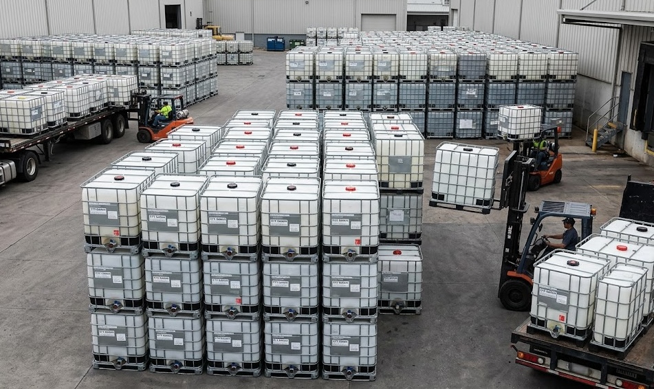 IBC tanks stacked at our facility with forklifts loading